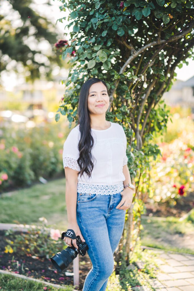 Female Photographer outdoors standing in front of a tree